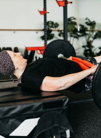 The photo shows a cancer patient working out